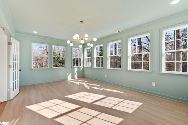 unfurnished sunroom with a healthy amount of sunlight, visible vents, and a chandelier