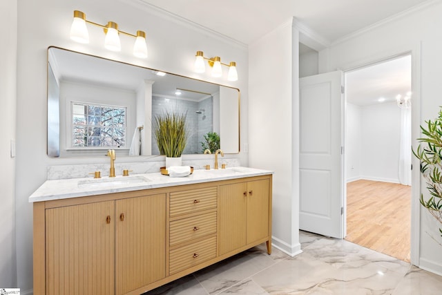 bathroom with crown molding, marble finish floor, and a sink