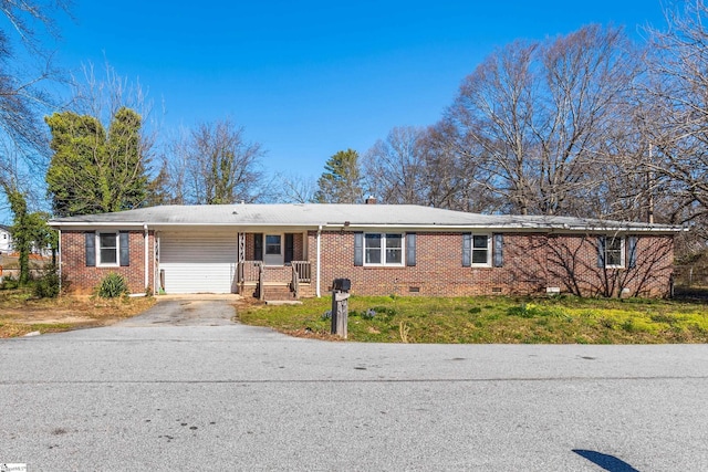 ranch-style home featuring brick siding, crawl space, an attached carport, driveway, and a front lawn