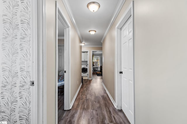 hallway with baseboards, washer / clothes dryer, dark wood finished floors, and crown molding