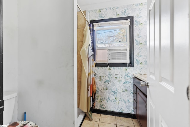 bathroom with curtained shower, wallpapered walls, toilet, baseboards, and tile patterned floors