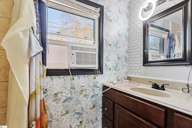 bathroom with wallpapered walls and vanity