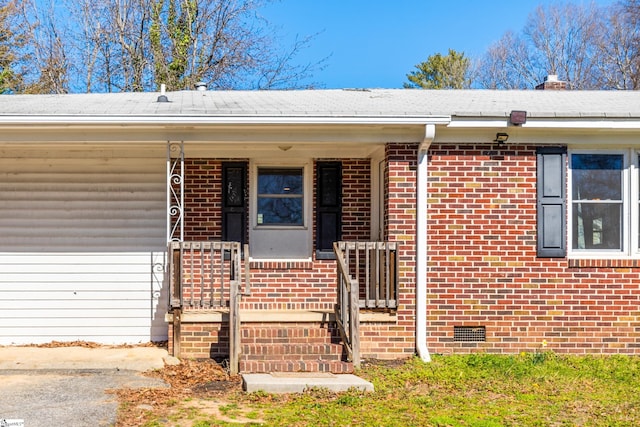 entrance to property with covered porch, brick siding, crawl space, and a chimney