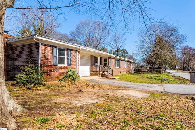 single story home with brick siding and a front yard