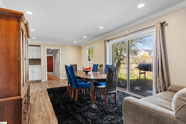 dining room with baseboards, recessed lighting, light wood-type flooring, and crown molding