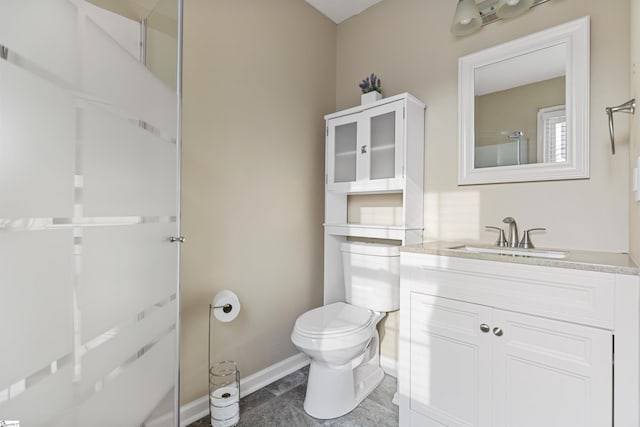 bathroom with walk in shower, vanity, toilet, and baseboards