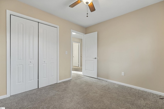 unfurnished bedroom featuring a closet, carpet, a ceiling fan, and baseboards