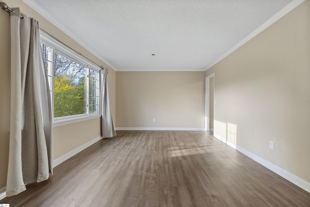 unfurnished room featuring crown molding, a textured ceiling, baseboards, and wood finished floors