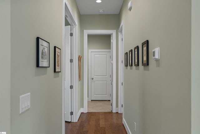 hall with baseboards, dark wood-type flooring, and recessed lighting