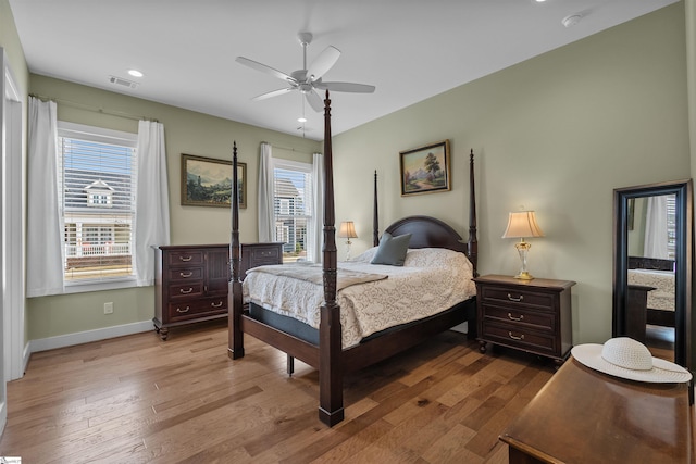 bedroom with visible vents, ceiling fan, baseboards, and wood finished floors