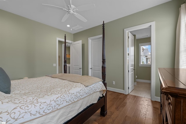 bedroom featuring ceiling fan, baseboards, and wood finished floors