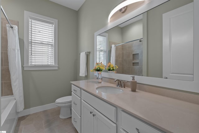 full bathroom with tile patterned flooring, toilet, vanity, baseboards, and shower / bath combo