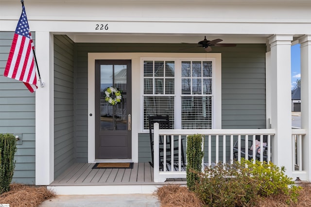 doorway to property with a porch and ceiling fan