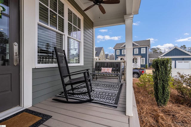 wooden deck featuring a porch and ceiling fan