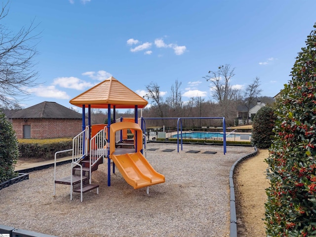 communal playground with an outdoor pool and fence