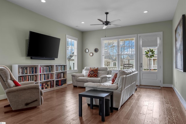 living area featuring ceiling fan, baseboards, wood finished floors, and recessed lighting