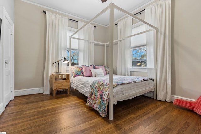 bedroom with baseboards and wood finished floors