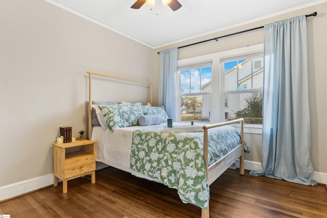 bedroom featuring crown molding, baseboards, and wood finished floors