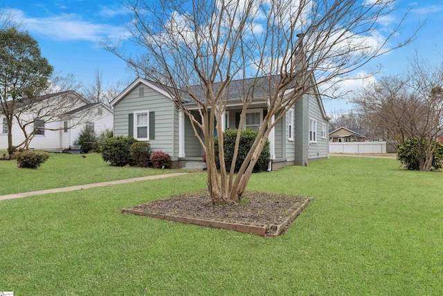 view of front of property with fence and a front lawn