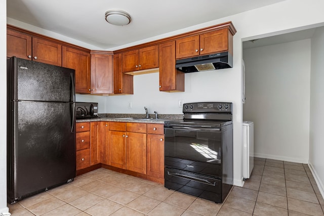 kitchen featuring light tile patterned flooring, under cabinet range hood, baseboards, black appliances, and brown cabinetry