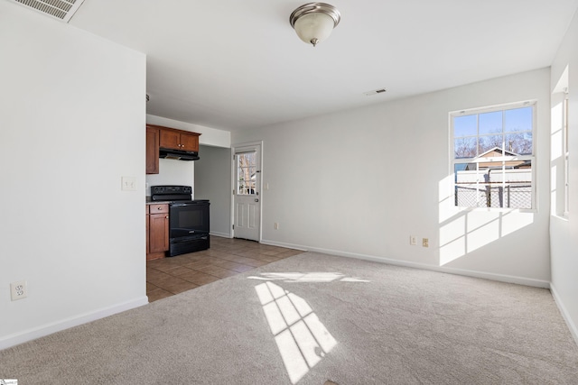 unfurnished living room featuring light carpet, visible vents, baseboards, and light tile patterned flooring