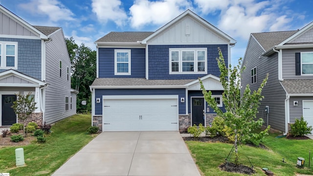 craftsman house featuring board and batten siding, a garage, stone siding, driveway, and a front lawn