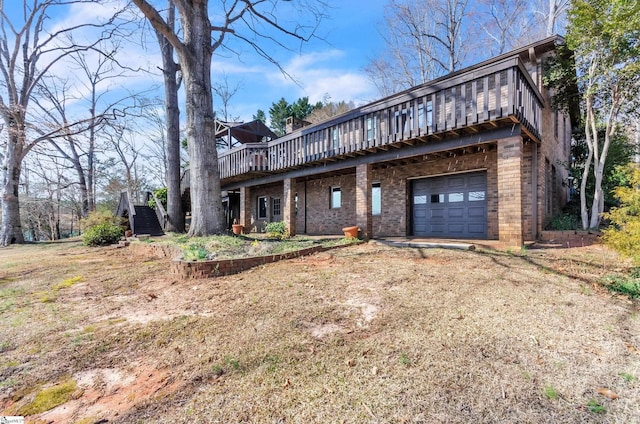 view of front of property with an attached garage, dirt driveway, a deck, and brick siding