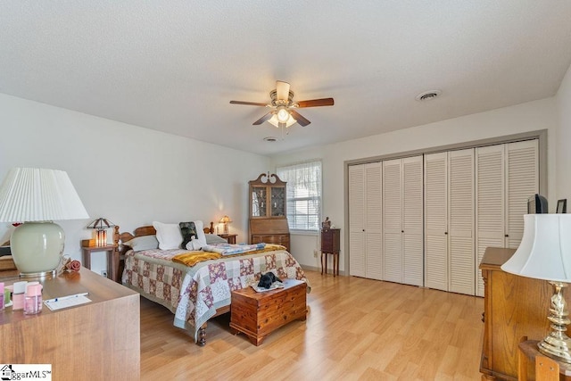 bedroom with ceiling fan, a closet, light wood-type flooring, and visible vents