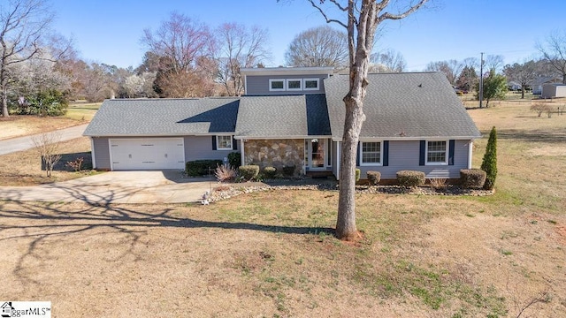 mid-century home featuring an attached garage, driveway, stone siding, roof with shingles, and a front yard