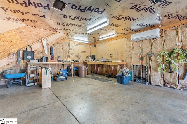 garage with an AC wall unit and a workshop area