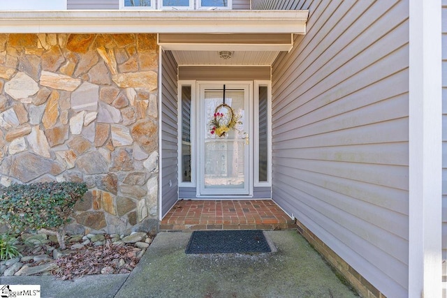 entrance to property with stone siding