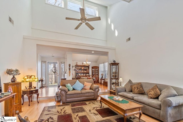 living area featuring visible vents, plenty of natural light, and light wood-style flooring