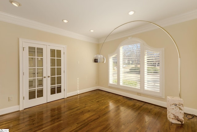 unfurnished room featuring french doors, crown molding, visible vents, wood finished floors, and baseboards