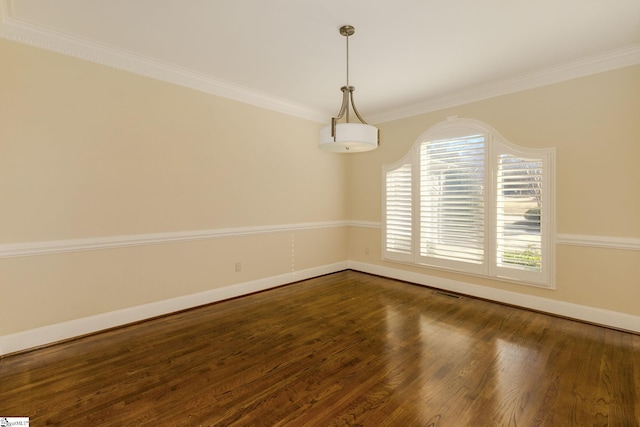 empty room with dark wood-style floors, visible vents, crown molding, and baseboards