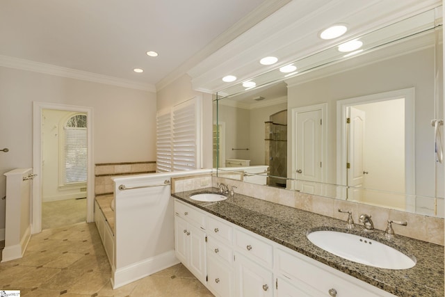 full bath featuring ornamental molding, a sink, and a bath