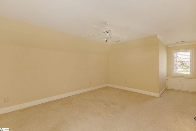 unfurnished room with baseboards, a ceiling fan, and light colored carpet