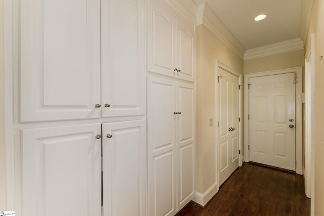 corridor with ornamental molding, dark wood-style flooring, and recessed lighting