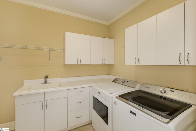 laundry room featuring cabinet space, washing machine and dryer, ornamental molding, and a sink