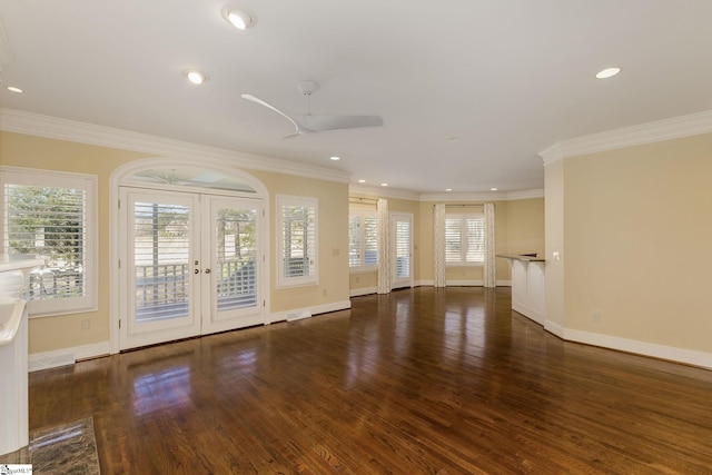 unfurnished living room with a healthy amount of sunlight, crown molding, and wood finished floors