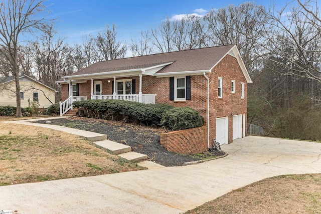 ranch-style house with an attached garage, covered porch, driveway, and brick siding