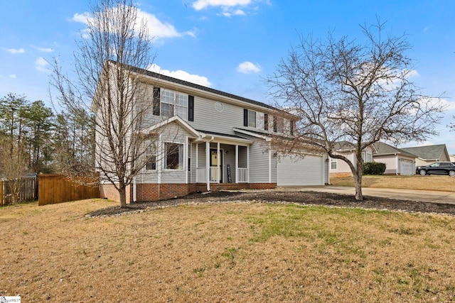 traditional-style house featuring a porch, a front yard, concrete driveway, and fence