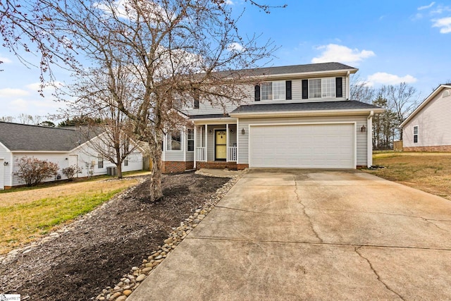 traditional-style home featuring a garage, driveway, a front lawn, and a shingled roof