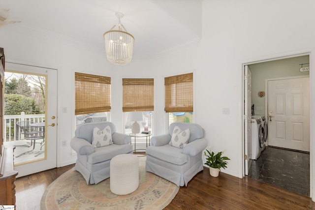 living area with a healthy amount of sunlight, ornamental molding, separate washer and dryer, and wood finished floors