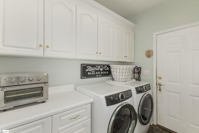 laundry area featuring a toaster, cabinet space, and washer and clothes dryer