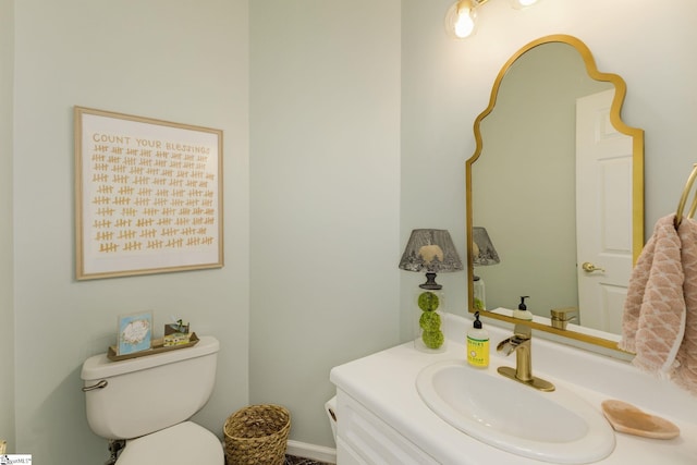 bathroom featuring vanity and toilet