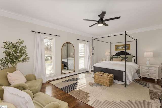 bedroom featuring ornamental molding, wood finished floors, and a ceiling fan