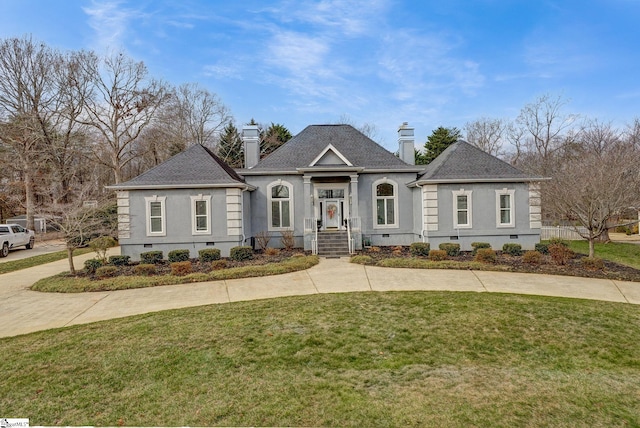 view of front of property with a shingled roof, crawl space, a chimney, and a front lawn