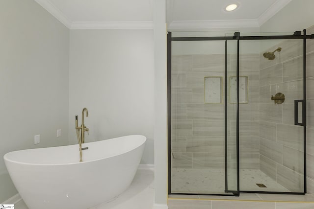 bathroom with a shower stall, baseboards, a freestanding tub, and crown molding