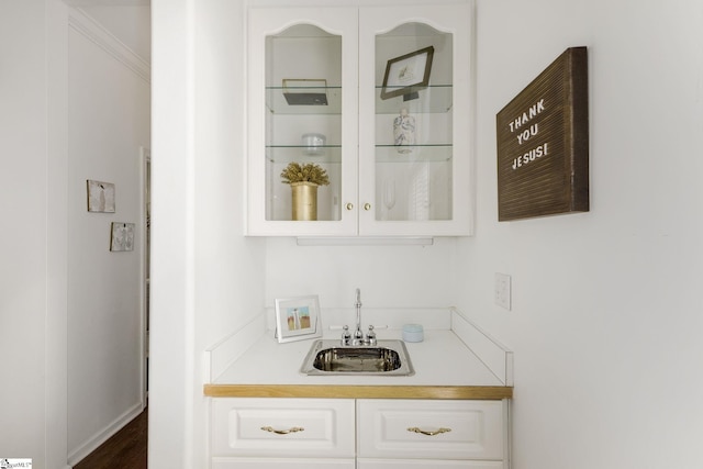 bar with indoor wet bar and a sink