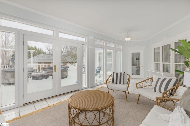 sunroom / solarium featuring a wealth of natural light, french doors, and ceiling fan